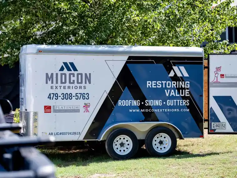 The Midcon Exteriors trailer with the logo, phone number and Owens Corning Platinum Preferred badge